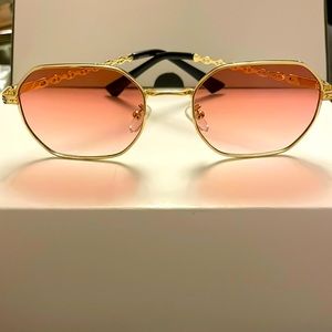 Gold metal octagon frame sunglasses with pink lenses